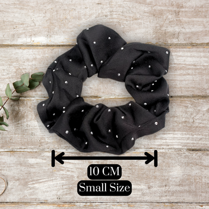 main image of black satin rhinestone scrunchies on a wood background