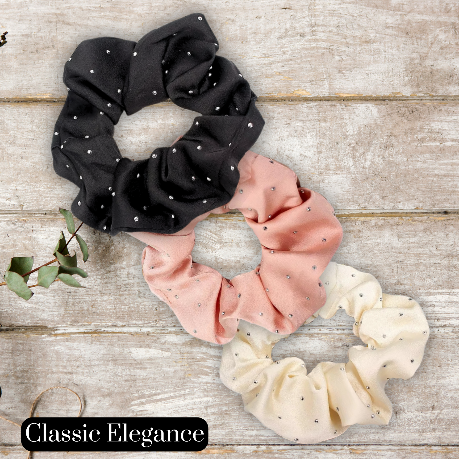 main image of black, rose gold and cream satin rhinestone scrunchies on a wood background