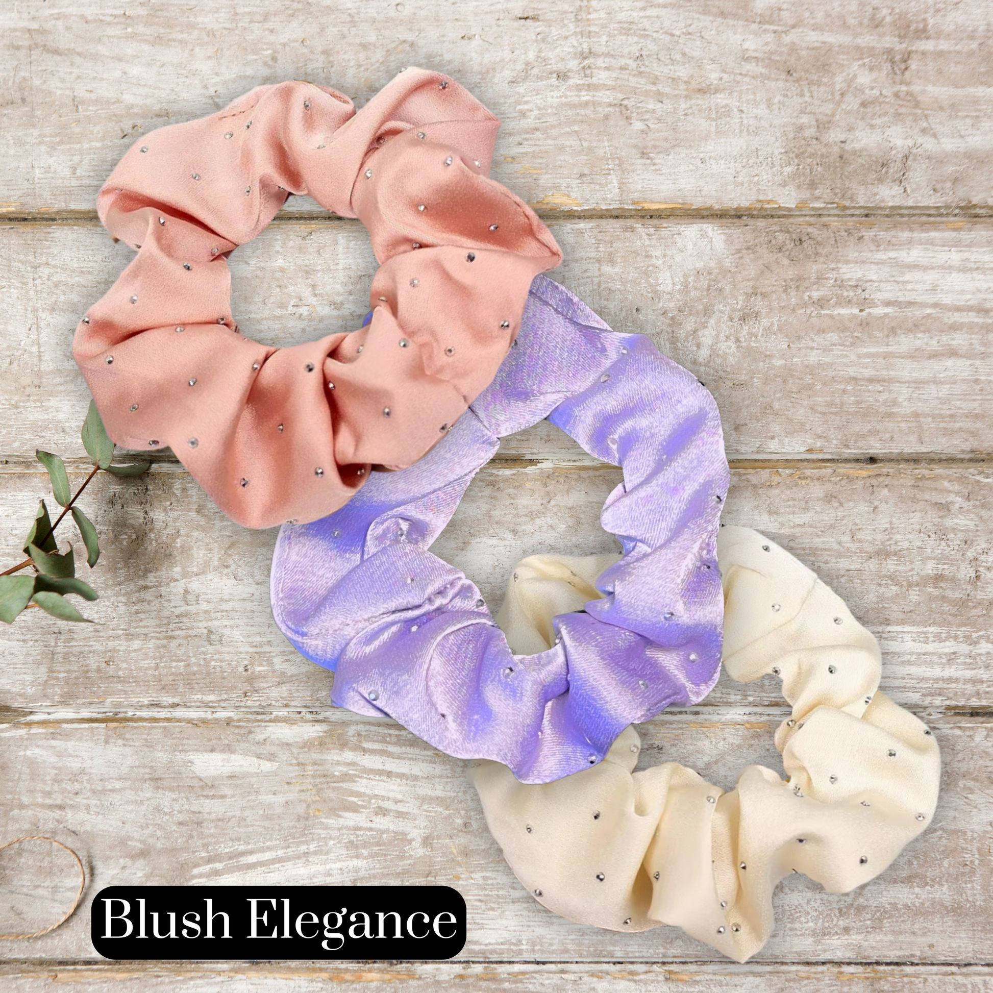 main image of rose gold, lavender, and cream satin rhinestone scrunchies on a wood background