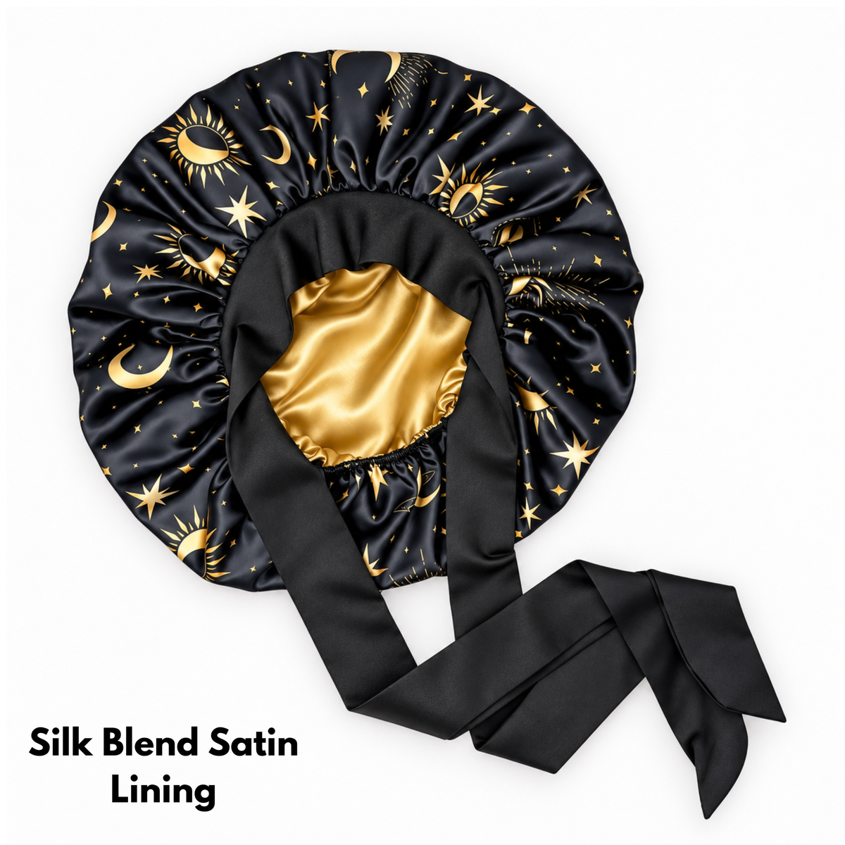 A black satin bonnet or hair wrap with a gold celestial print of stars and crescent moons, featuring a shiny gold satin inner lining and long black satin ties, shown on a white background with text reading 'Silk Blend Satin Lining'.