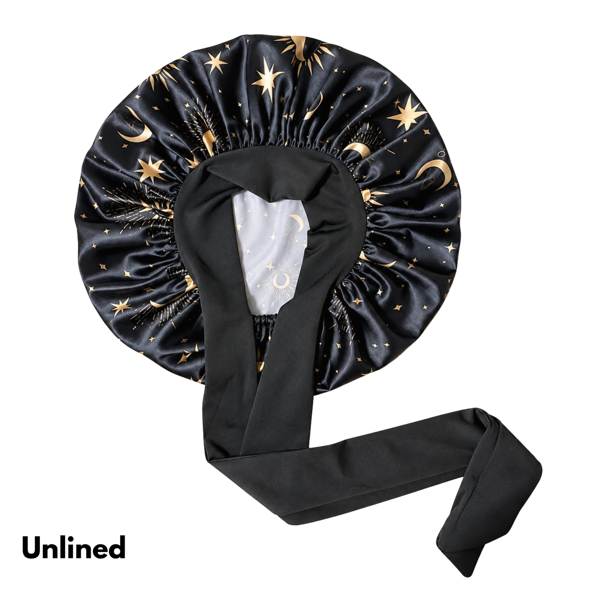 Black satin bonnet with a gold celestial print of stars and crescent moons, featuring a long black tie strap, shown on a white background with the text 'Unlined' in the bottom-left corner.