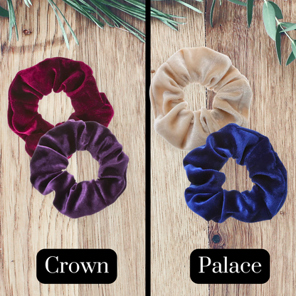 burgundy, purple, beige and royal blue velvet scrunchies on a wooden background.