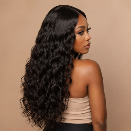 Model wearing natural black virgin Brazilian natural wave human hair bundles in a middle-part sew-in